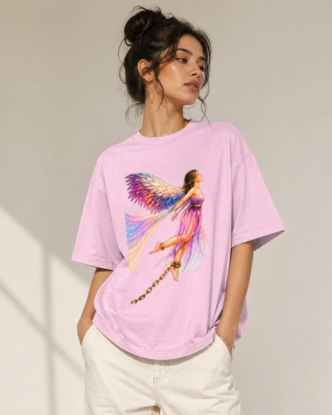 Front view of a Baby Pink heavyweight oversized t-shirt with a colorful butterfly angel graphic and relaxed boxy fit.
