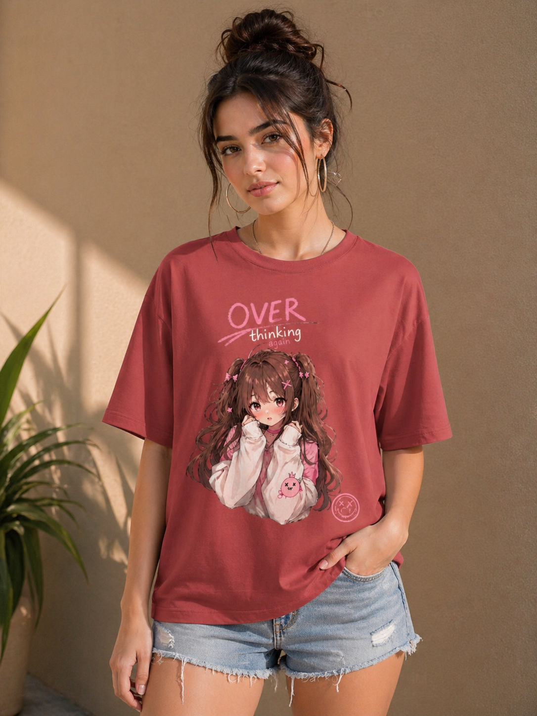 Side profile of the coral oversized t-shirt highlighting the drop-shoulder construction and structured cotton feel.