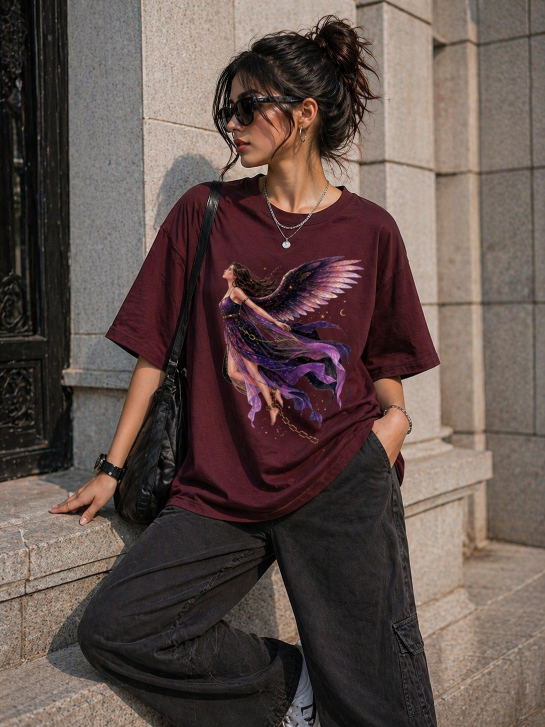Maroon heavyweight t-shirt highlighting the detailed purple angel artwork and structured drop-shoulder silhouette.