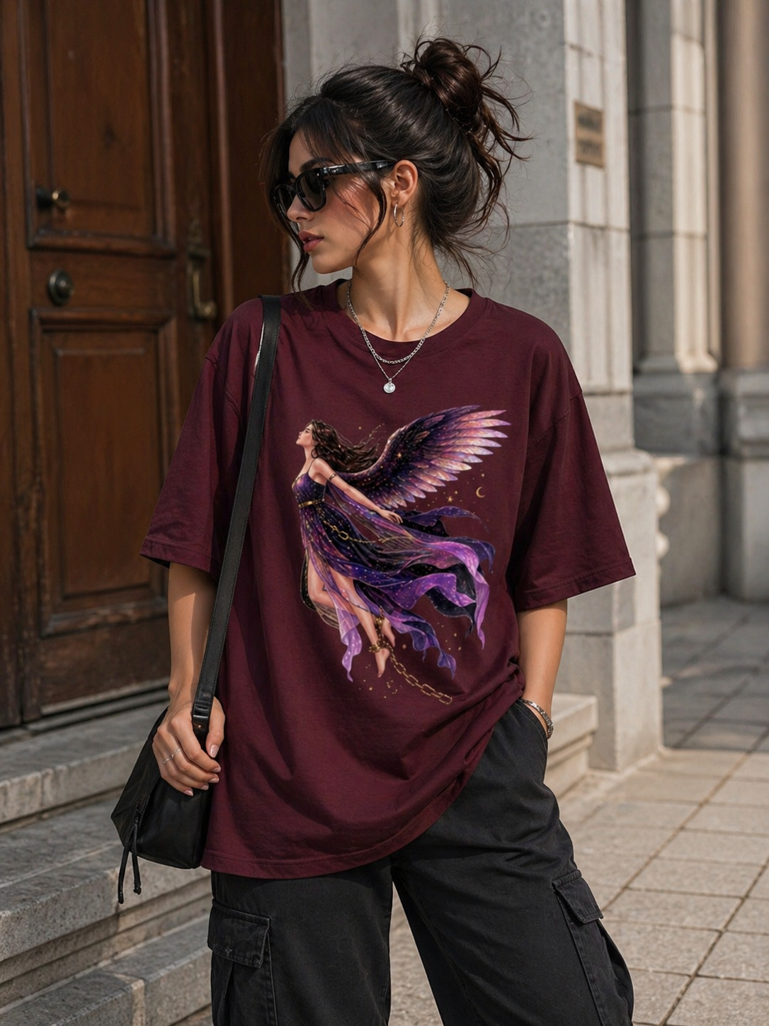 Maroon heavyweight t-shirt highlighting the detailed purple angel artwork and structured drop-shoulder silhouette.
