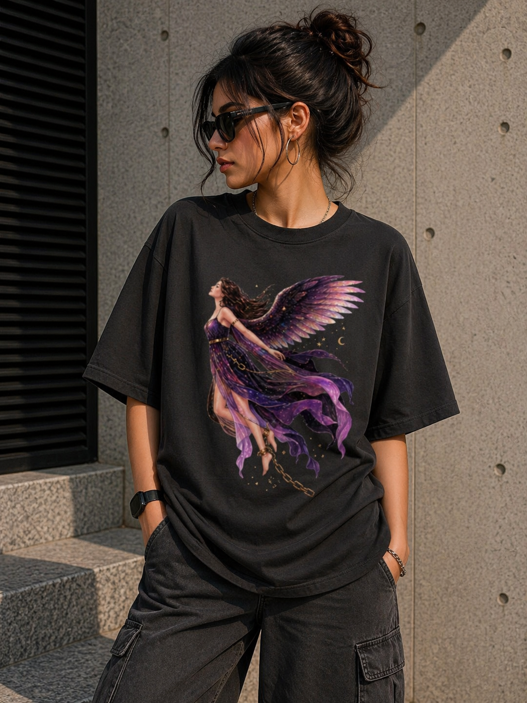 Front view of a black heavyweight oversized t-shirt with a vibrant purple angel graphic, showcasing an aesthetic urban look.