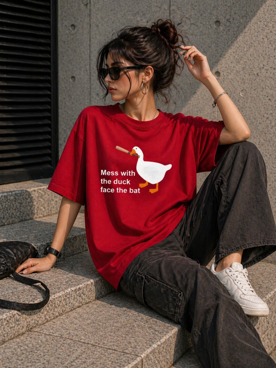 Side profile view of the red oversized graphic tee showing the relaxed boxy fit and vibrant color.