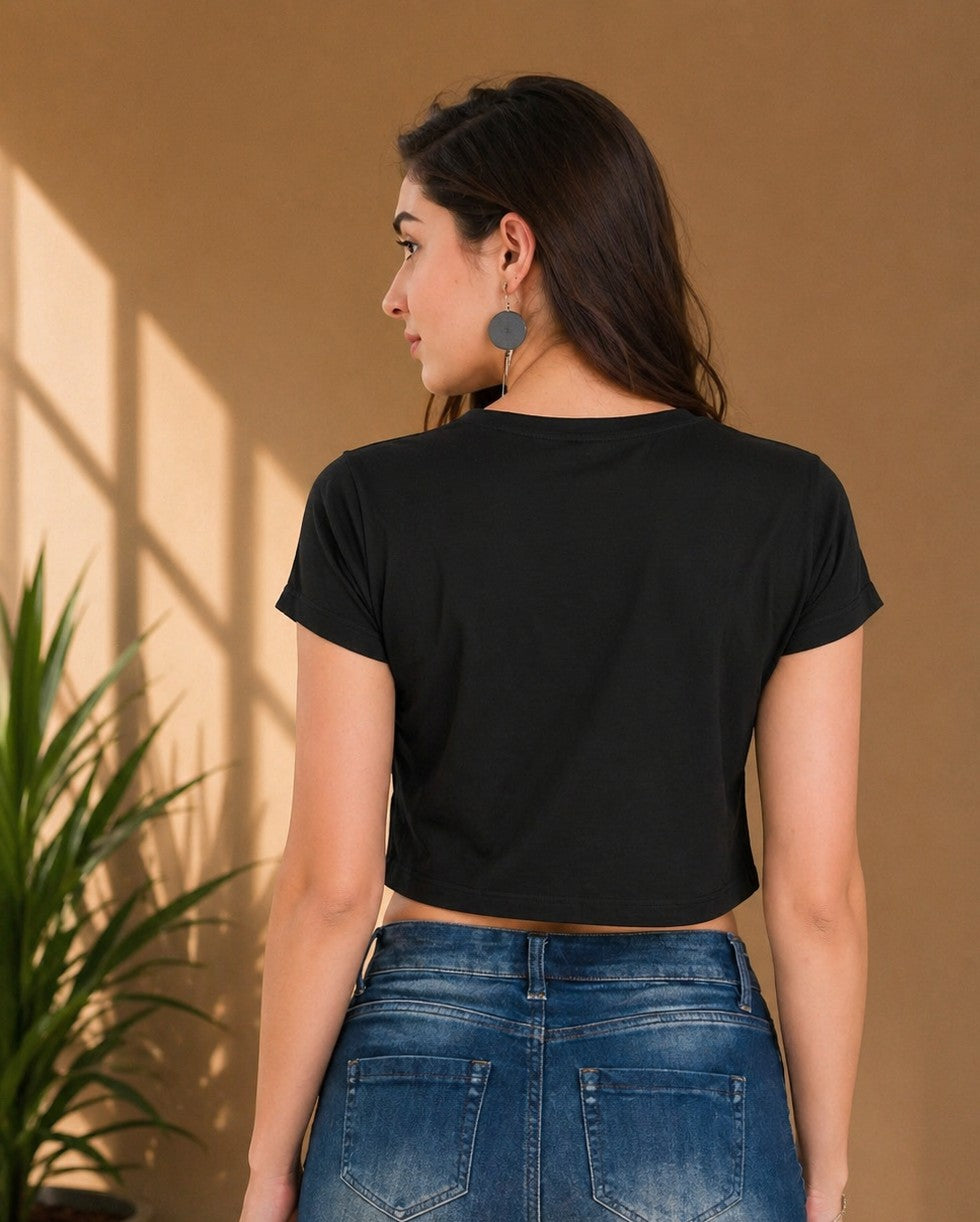 Back view of the black graphic crop top showcasing the flattering slim fit and short silhouette.
