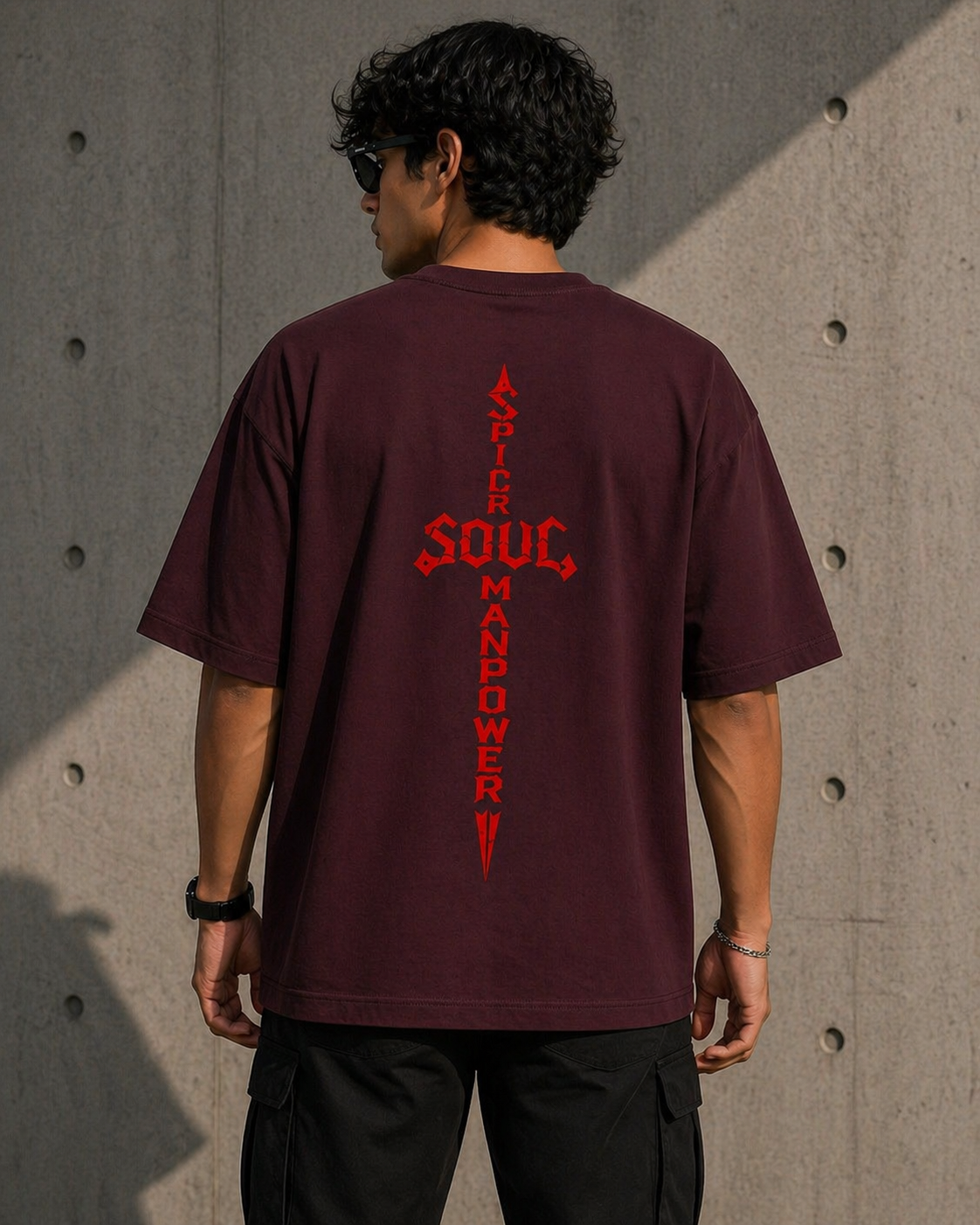 Maroon heavyweight oversized t-shirt with a minimal red chest logo and a bold vertical sword back print.
