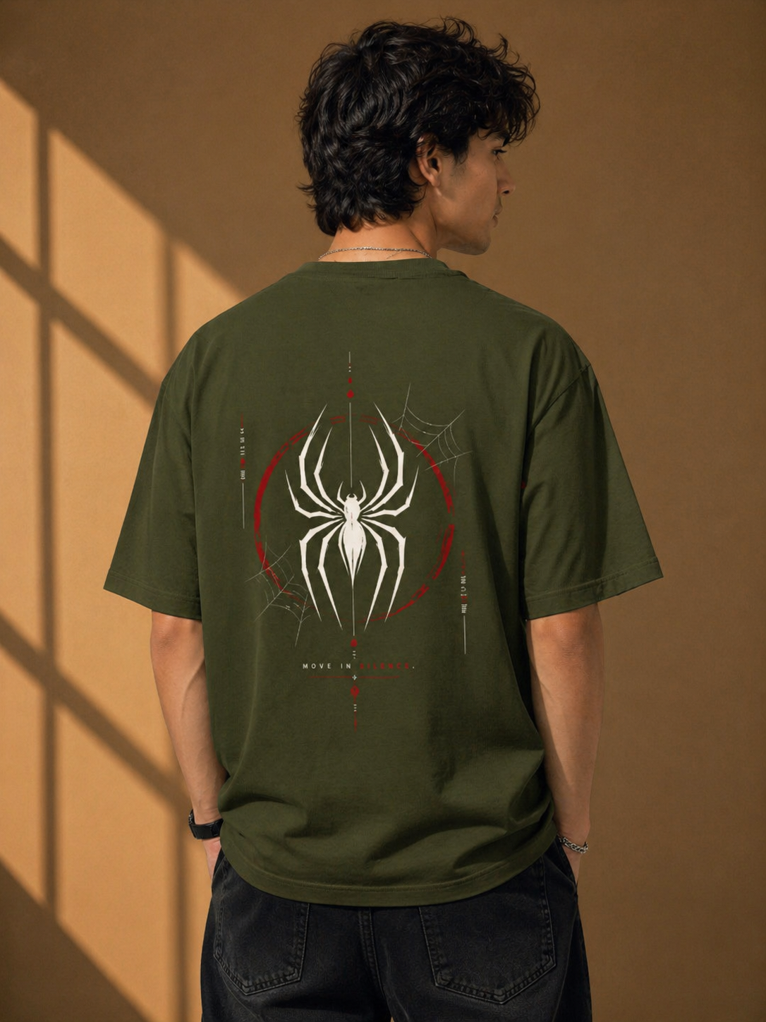 Back view of a olive heavyweight oversized t-shirt with a striking white and red spider graphic print for an edgy streetwear look.